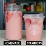 better-than-starbucks pink drink in a glass with strawberries and ice