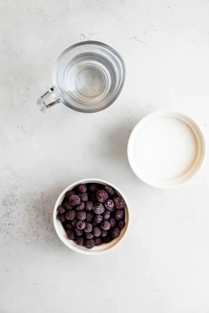 Homemade blueberry syrup ingredients on counter